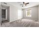 Light-filled bedroom with carpet, ceiling fan, double door closet and large window at 6713 S Jentilly Ln, Tempe, AZ 85283