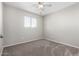 This light filled bedroom features neutral walls, plush carpet and a ceiling fan at 6713 S Jentilly Ln, Tempe, AZ 85283