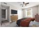 Cozy bedroom with a ceiling fan, comfortable bed, and natural light from the window at 6713 S Jentilly Ln, Tempe, AZ 85283
