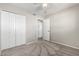 Bedroom featuring plush carpet, ceiling fan and closet space for storage at 6713 S Jentilly Ln, Tempe, AZ 85283