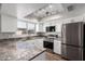 Updated kitchen with stainless steel appliances, track lighting, and white cabinets at 6713 S Jentilly Ln, Tempe, AZ 85283