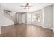 Bright living room with hardwood floors, large windows, staircase, and ample space for furniture at 6713 S Jentilly Ln, Tempe, AZ 85283