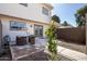 Cozy patio with outdoor seating, gravel landscaping, and privacy fence near the back entrance at 6713 S Jentilly Ln, Tempe, AZ 85283