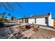The expansive backyard features a firepit and seating, lush greenery, a refreshing pool, and plenty of room for outdoor living at 6729 E Sharon Dr, Scottsdale, AZ 85254