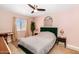 Modern bedroom with a green headboard, a desk, and a large window at 6729 E Sharon Dr, Scottsdale, AZ 85254