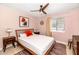 Bedroom features a ceiling fan, wood bed frame, and a large window at 6729 E Sharon Dr, Scottsdale, AZ 85254