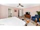 Comfortable bedroom features a ceiling fan, television, and sitting area with a geometric rug at 6729 E Sharon Dr, Scottsdale, AZ 85254