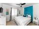 Bedroom with a ceiling fan, white metal bed frame, and white and blue drapes at 6729 E Sharon Dr, Scottsdale, AZ 85254
