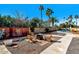 Cozy outdoor seating area with a firepit, mature trees, privacy fence, and proximity to the pool for evening gatherings at 6729 E Sharon Dr, Scottsdale, AZ 85254