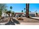 Charming single-story home featuring desert landscaping and a front porch with arched accents at 6729 E Sharon Dr, Scottsdale, AZ 85254
