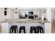 Kitchen island with countertop seating, updated appliances, and a view into the adjoining dining space at 6729 E Sharon Dr, Scottsdale, AZ 85254