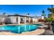 Backyard with a refreshing pool, covered patio, and desert landscaping at 6729 E Sharon Dr, Scottsdale, AZ 85254