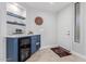 Stylish bar area with wine fridge and custom shelving, perfect for entertaining guests at 7700 E Gainey Ranch Rd # 127, Scottsdale, AZ 85258
