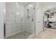 Modern bathroom featuring a frameless glass shower with stylish tile and a spacious walk-in closet at 7700 E Gainey Ranch Rd # 127, Scottsdale, AZ 85258