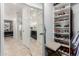 Hallway view of the updated bathroom, complete with sleek vanity, stylish mirrors, and walk-in closet at 7700 E Gainey Ranch Rd # 127, Scottsdale, AZ 85258