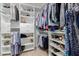 Organized walk-in closet with custom shelving and rods for optimal storage and clothing display at 7700 E Gainey Ranch Rd # 127, Scottsdale, AZ 85258