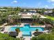 Community pool and lush grounds with lounge chairs and umbrellas for luxurious relaxation at 7700 E Gainey Ranch Rd # 127, Scottsdale, AZ 85258