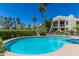 Refreshing community pool with lounge chairs, mature trees, and well-maintained landscaping at 7700 E Gainey Ranch Rd # 127, Scottsdale, AZ 85258