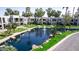 Community view of condos surrounding a tranquil pond with fountain features and mature landscaping at 7700 E Gainey Ranch Rd # 127, Scottsdale, AZ 85258