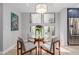 Cozy dining area features a glass table, seating for four, and bright natural light from the large picture window at 7700 E Gainey Ranch Rd # 127, Scottsdale, AZ 85258