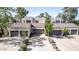 Contemporary townhome exterior featuring garages, driveways, and manicured landscaping at 7700 E Gainey Ranch Rd # 127, Scottsdale, AZ 85258