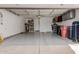 Spacious garage with epoxy flooring, storage shelves, and ample room for vehicles and storage at 7700 E Gainey Ranch Rd # 127, Scottsdale, AZ 85258