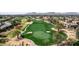 Aerial view of a manicured golf course in a residential area with mountains in the distance at 7700 E Gainey Ranch Rd # 127, Scottsdale, AZ 85258