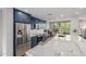 Bright, spacious kitchen with stainless steel appliances, blue cabinetry, marble countertops, and open-concept design at 7700 E Gainey Ranch Rd # 127, Scottsdale, AZ 85258