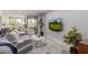 Bright living room with neutral tones, modern furnishings, and a large sliding glass door leading to outdoor space at 7700 E Gainey Ranch Rd # 127, Scottsdale, AZ 85258