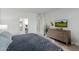 Comfortable main bedroom features a plush king bed, stylish dresser, and bright natural light from the bedroom window at 7700 E Gainey Ranch Rd # 127, Scottsdale, AZ 85258