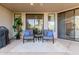 Relaxing patio with comfortable seating, rug, and view through sliding glass door at 7700 E Gainey Ranch Rd # 127, Scottsdale, AZ 85258