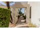 A walkway showcasing the architecture of the community and featuring mature landscaping at 7700 E Gainey Ranch Rd # 127, Scottsdale, AZ 85258