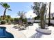Expansive backyard with a trampoline, lounge chairs, and dining area provides ample space for outdoor activities at 8717 E Spanish Barb Trl, Scottsdale, AZ 85258