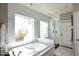 Bright bathroom with a bathtub, shower stall, tile flooring, and a frosted window at 8717 E Spanish Barb Trl, Scottsdale, AZ 85258