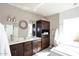 Bright bathroom with double sinks, dark wood cabinets, bathtub, and white tile at 8717 E Spanish Barb Trl, Scottsdale, AZ 85258
