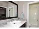 Bathroom featuring a modern sink, framed mirror, and a doorway to a shower/tub combo at 8717 E Spanish Barb Trl, Scottsdale, AZ 85258