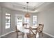 Bright breakfast nook features a round table and views of the pool and backyard at 8717 E Spanish Barb Trl, Scottsdale, AZ 85258