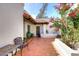 Inviting courtyard with vibrant flowers, a brick-paved patio, and a cozy seating area at 8717 E Spanish Barb Trl, Scottsdale, AZ 85258