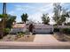 Charming white home with a red tile roof, two-car garage and drought tolerant desert landscaping at 8717 E Spanish Barb Trl, Scottsdale, AZ 85258
