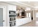 Open kitchen boasts granite countertops, stainless steel appliances, and seamless flow to living area at 8717 E Spanish Barb Trl, Scottsdale, AZ 85258