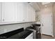 Laundry room features sleek countertops, ample storage, and modern appliances at 8717 E Spanish Barb Trl, Scottsdale, AZ 85258