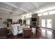 Spacious living room featuring coffered ceilings, a stone fireplace, and hardwood floors at 8717 E Spanish Barb Trl, Scottsdale, AZ 85258