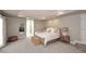 Bright main bedroom with carpeting, tray ceiling, furnishings, and a side door at 8717 E Spanish Barb Trl, Scottsdale, AZ 85258