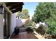 Quaint outdoor patio with tiled floor, garden view, and a tranquil sitting area with lush plants at 8717 E Spanish Barb Trl, Scottsdale, AZ 85258