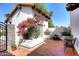 Charming outdoor patio with brick pavers, lush plants, and a cozy seating area at 8717 E Spanish Barb Trl, Scottsdale, AZ 85258