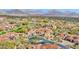Aerial view of a desert community featuring mature trees and mountains in the background at 8965 E Mountain Spring Rd, Scottsdale, AZ 85255