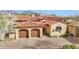 Home's aerial view highlights the desert landscaping, brick driveway and two car garage at 8965 E Mountain Spring Rd, Scottsdale, AZ 85255