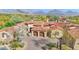 Stunning aerial view of home with mountain views, tile roof, desert landscaping, and private two car garage at 8965 E Mountain Spring Rd, Scottsdale, AZ 85255