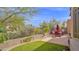 Landscaped backyard with patio, dining set, turf, and desert plants at 8965 E Mountain Spring Rd, Scottsdale, AZ 85255
