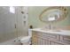 Elegant bathroom with a glass-enclosed shower, decorative mirror, and custom vanity with gold fixtures at 8965 E Mountain Spring Rd, Scottsdale, AZ 85255